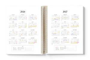 Spiral-bound planner with 2026 and 2027 calendar pages on a white background