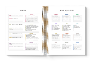 Spiral-bound planner with monthly progress tracker on a white background